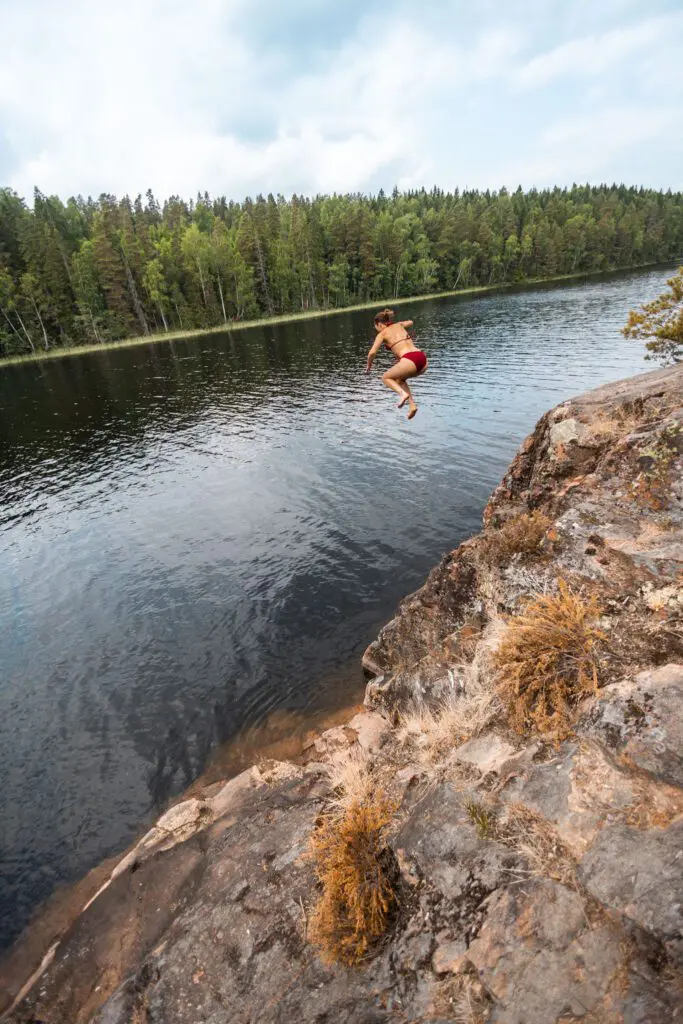 person jumping lake