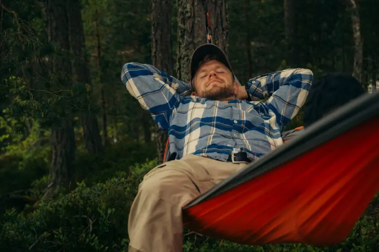 man relaxing in a hammock in a forest