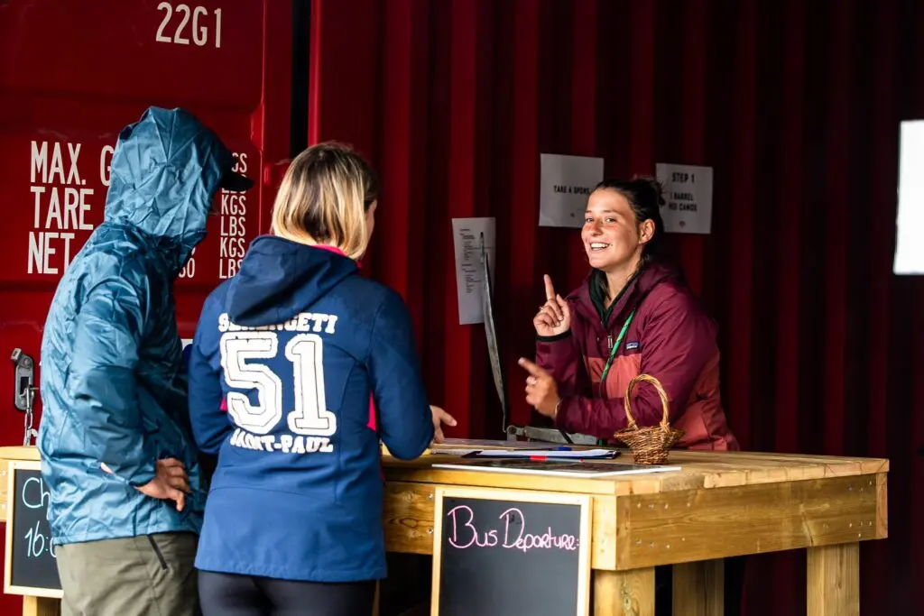 staff member talking to guests at a check-in desk