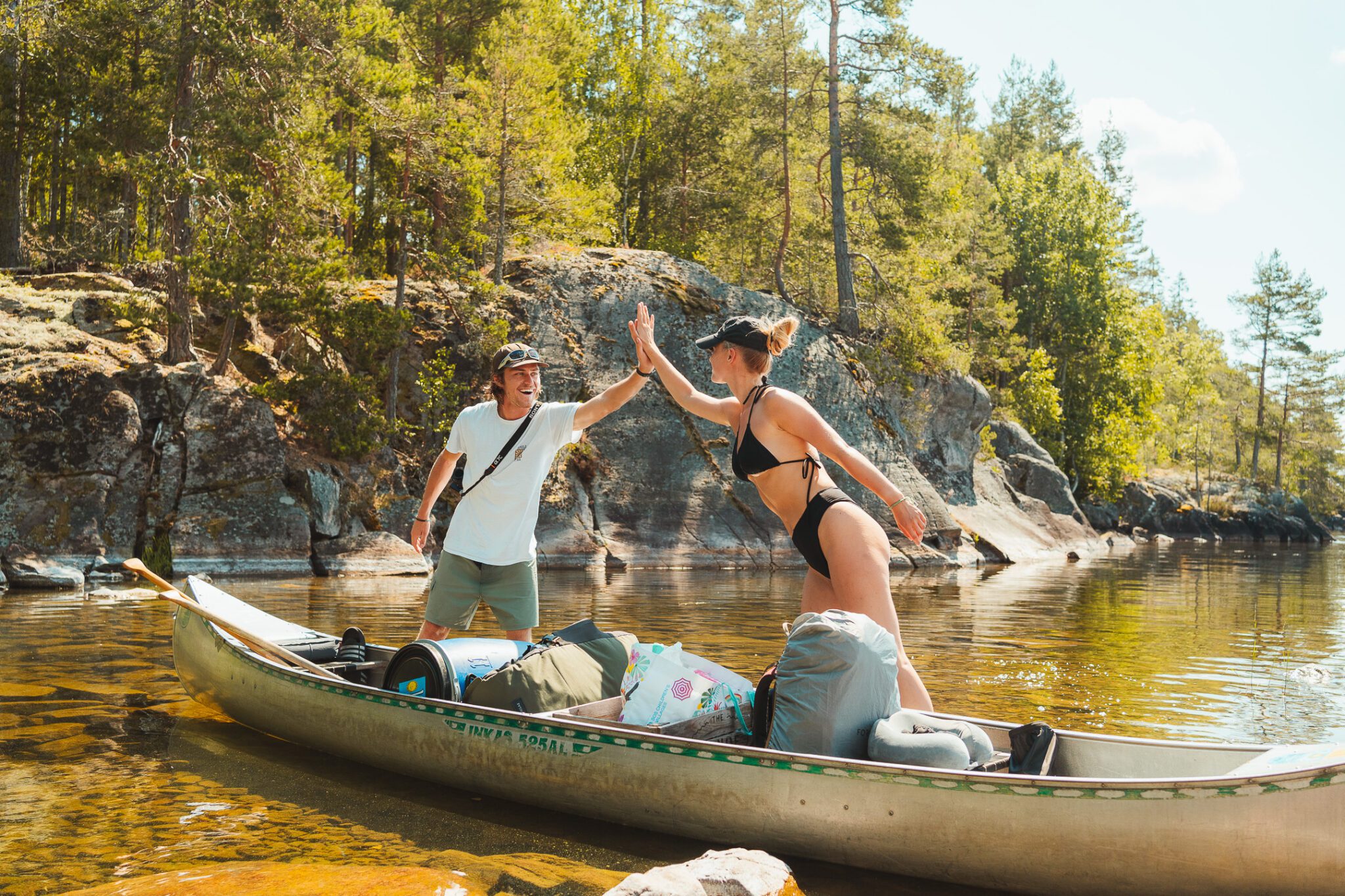Two happy friends doing The Canoe Trip canoeing in Sweden
