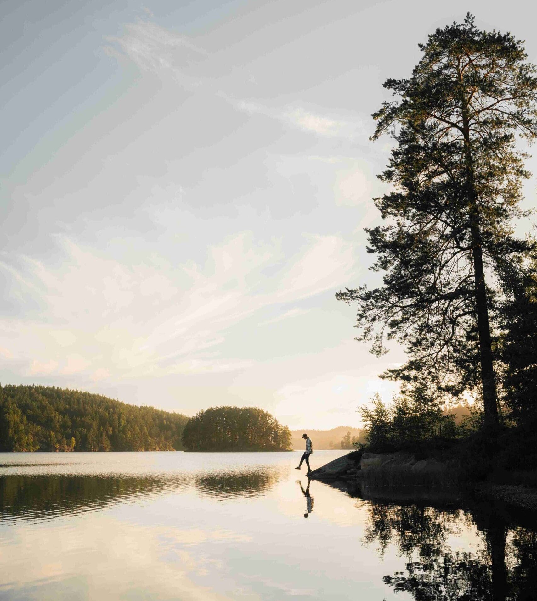 A man in front of a lake